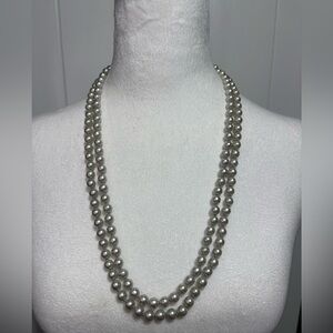 Long strand of grey tinted faux pearls